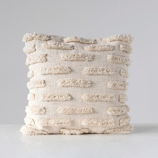 Textured beige pillow on a light gray background