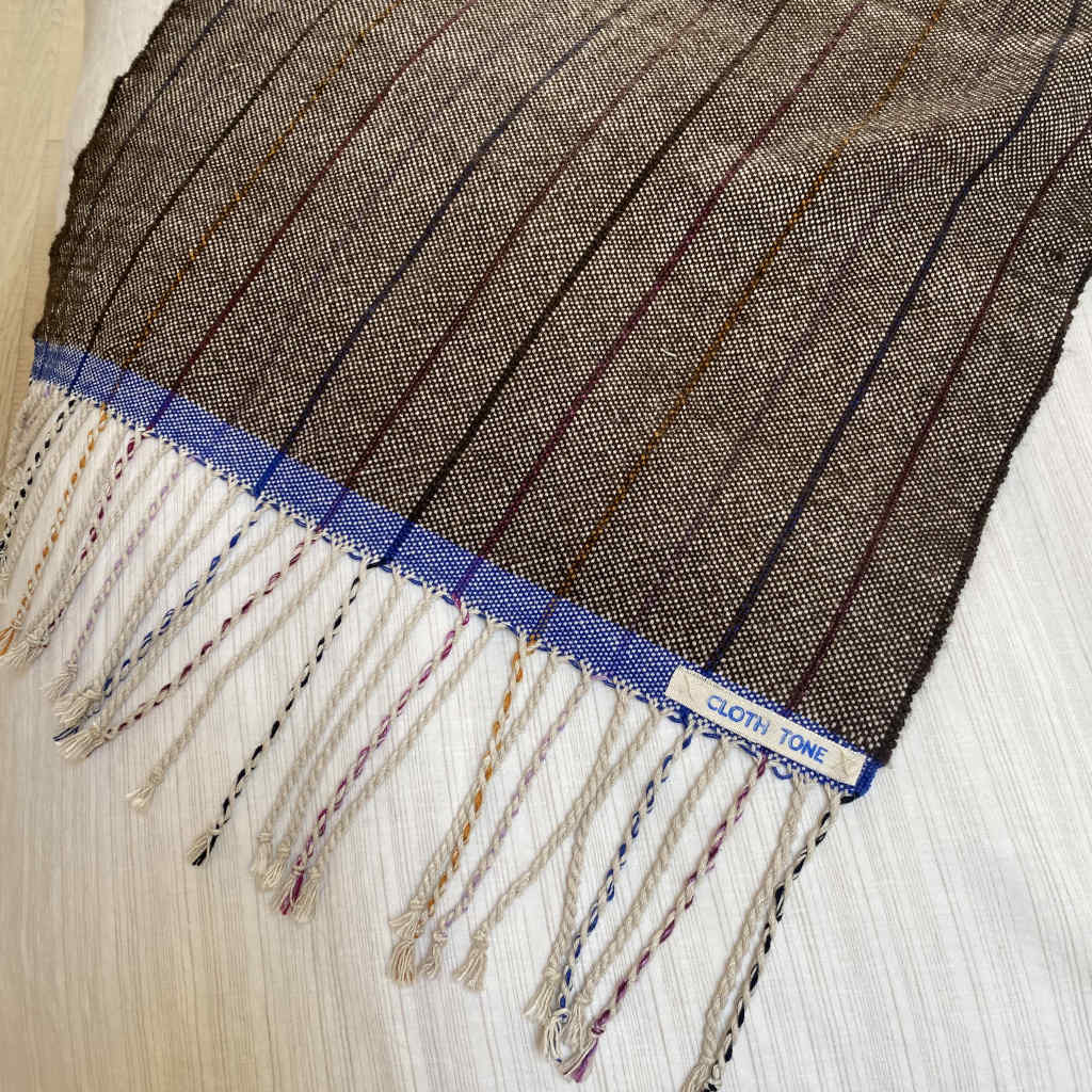 Close-up of woven fabric with a label on a white background