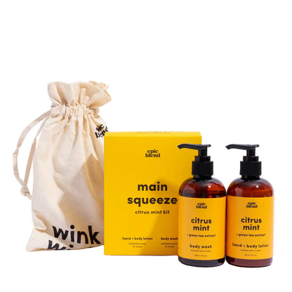 Epic Blend citrus mint body care set with a yellow box, two bottles, and a beige drawstring bag on a white background.