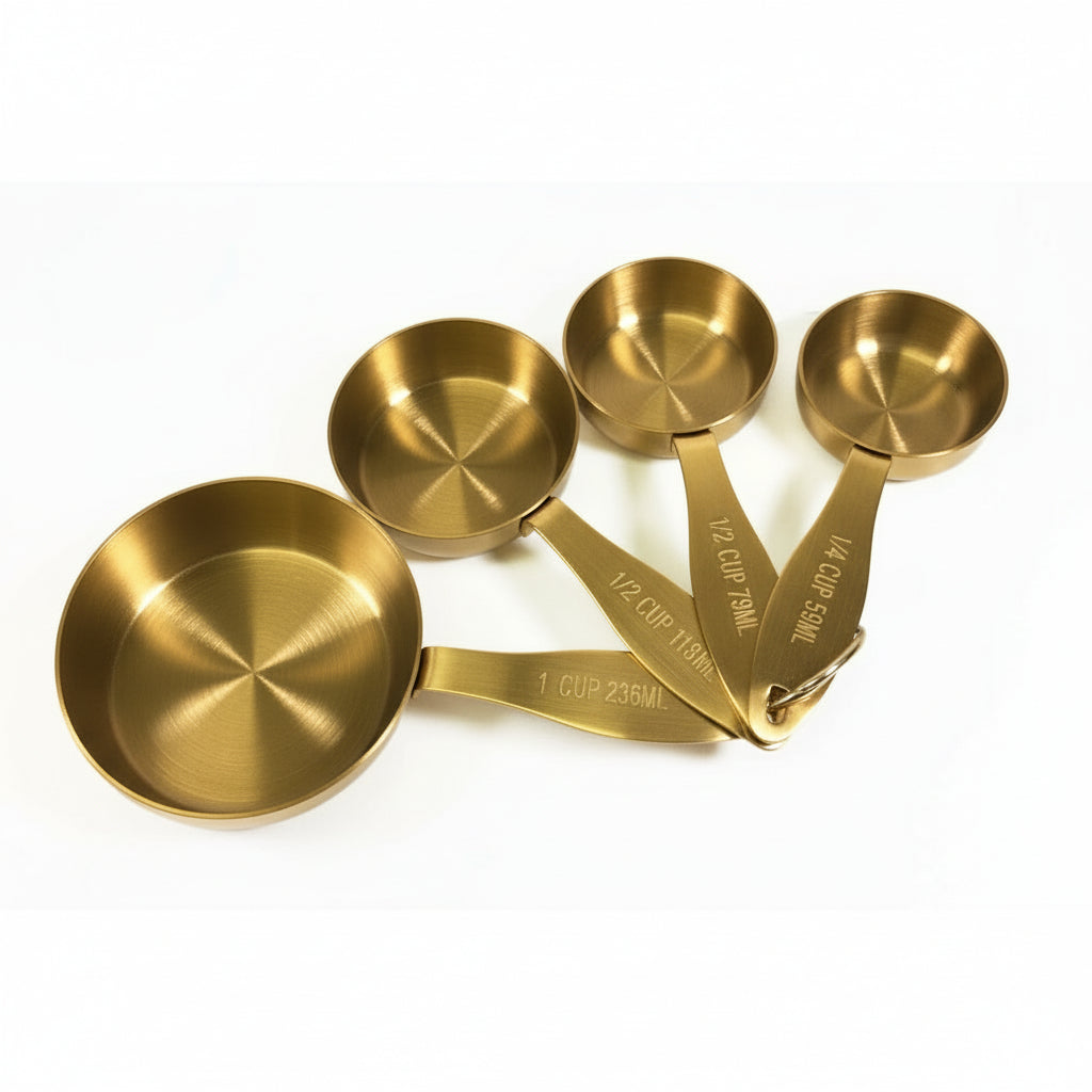 Set of gold measuring cups on a white background