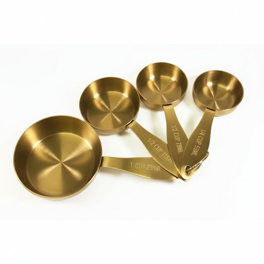 Set of gold measuring cups on a white background