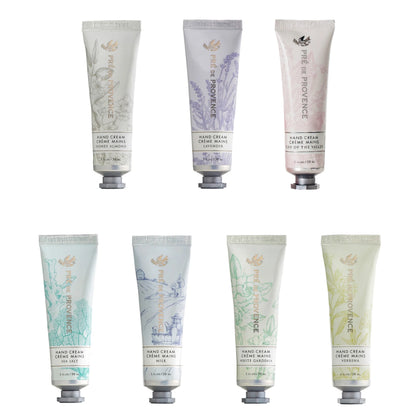 A collection of hand cream tubes from Pré de Provence in various colors and designs, labeled with different fragrances such as Lavender, Jasmine, and Citrus.