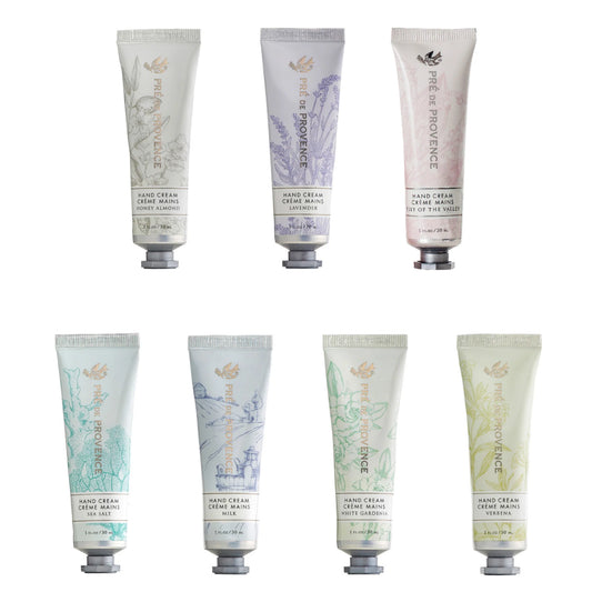 A collection of hand cream tubes from Pré de Provence in various colors and designs, labeled with different fragrances such as Lavender, Jasmine, and Citrus.