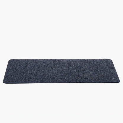 Rectangular dark gray desk mat on a white background