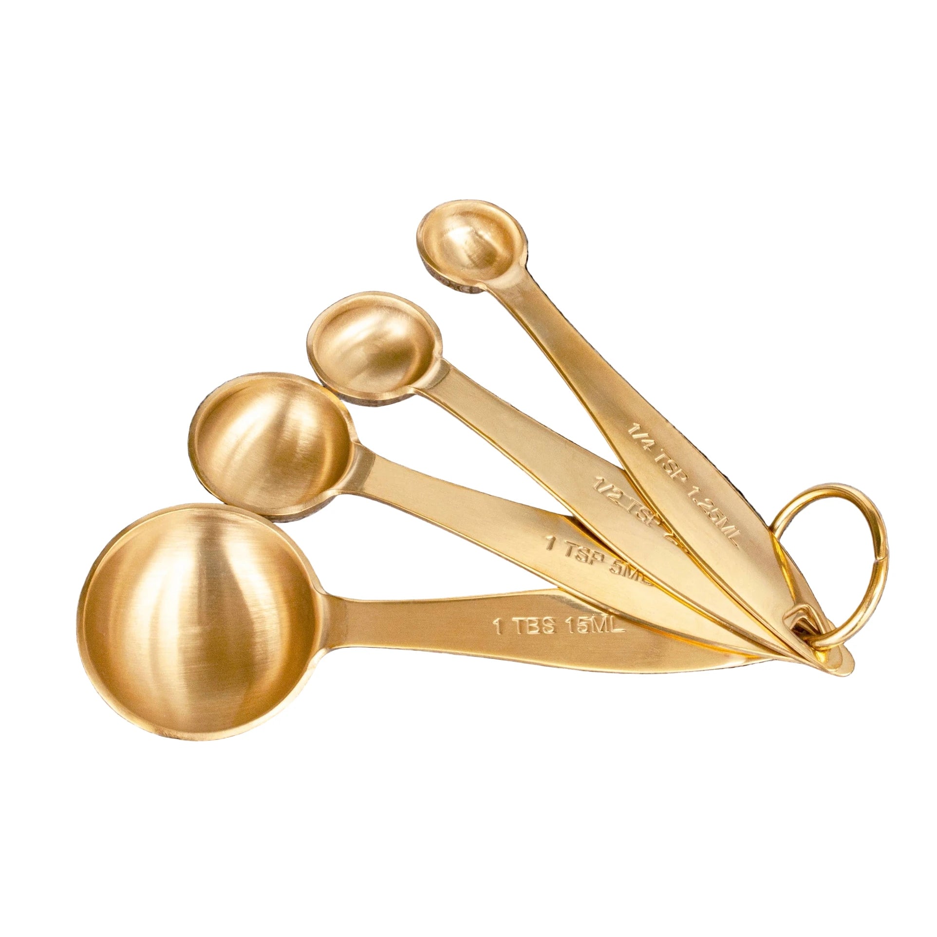 Set of gold measuring spoons on a white background