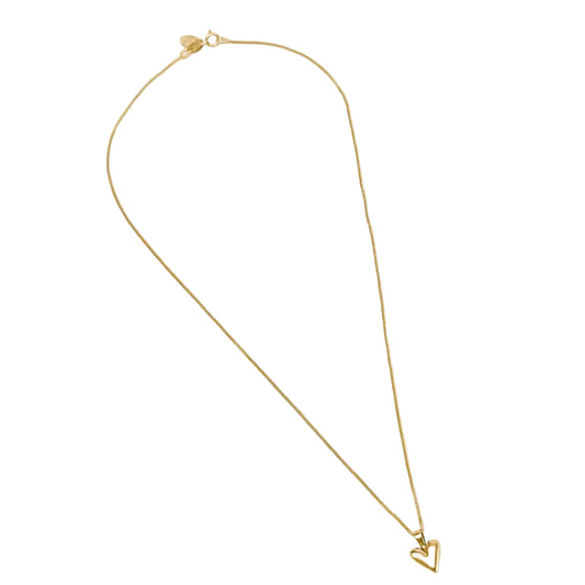 Gold necklace with a heart pendant on a light gray background