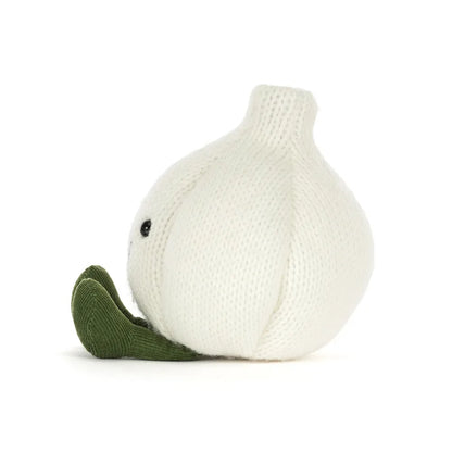 A knitted garlic plush toy in off-white with a dark green stem and leaf, featuring a small black bead eye, shown on a plain white background.