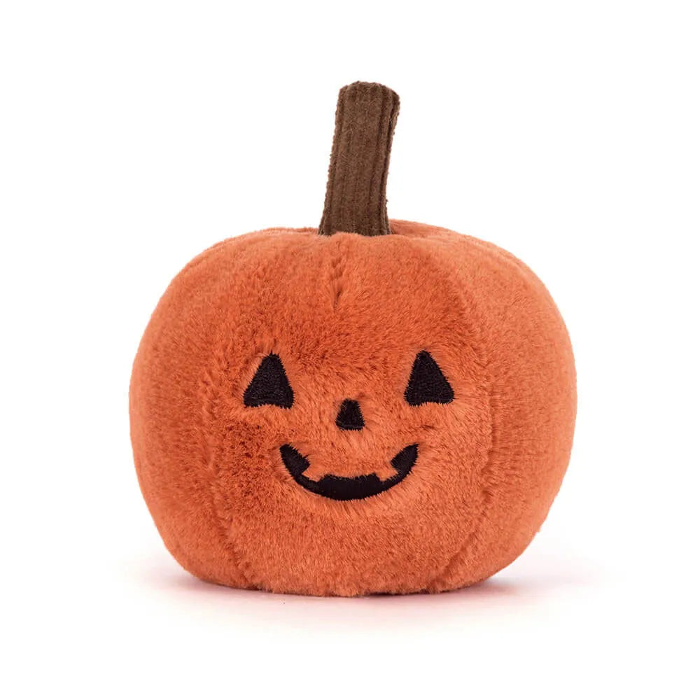 Plush pumpkin toy with a smiling face on a white background