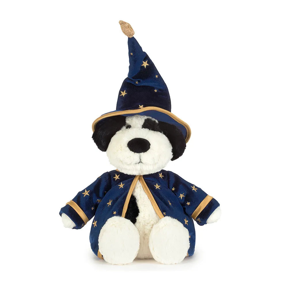 A plush dog stuffed animal dressed as a wizard, wearing a navy blue pointed hat and matching robe with gold star patterns and trim, on a plain white background.
