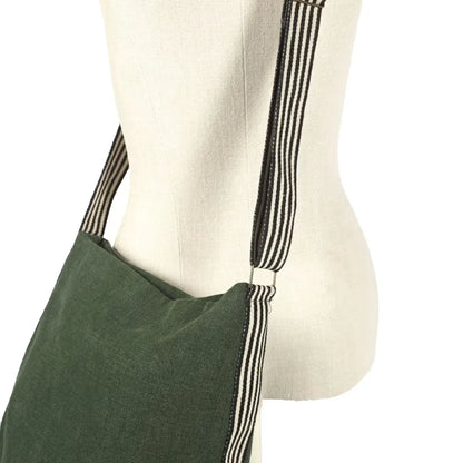 An olive green fabric shoulder bag with black and white striped straps, displayed on a cream-colored fabric mannequin torso against a white background.