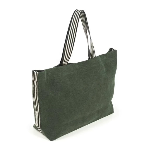 A dark green linen tote bag with black and white striped fabric handles and side trim, shown on a plain white background.