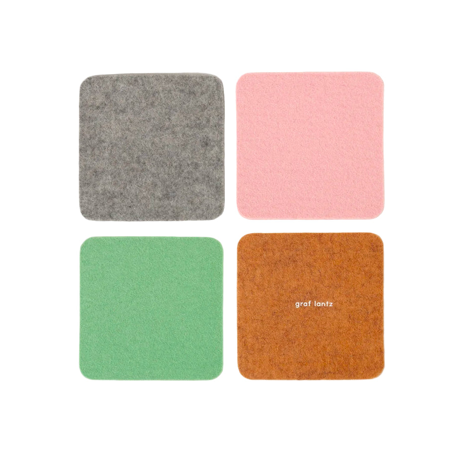 Four square coasters in gray, pink, green, and brown with 'graf lantz' branding on a white background.
