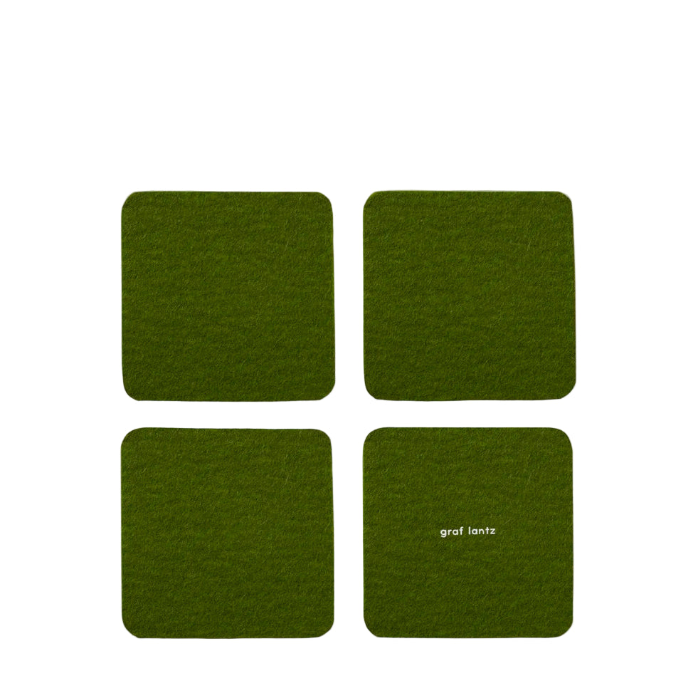 Four green coasters with 'graf lantz' branding on a white background