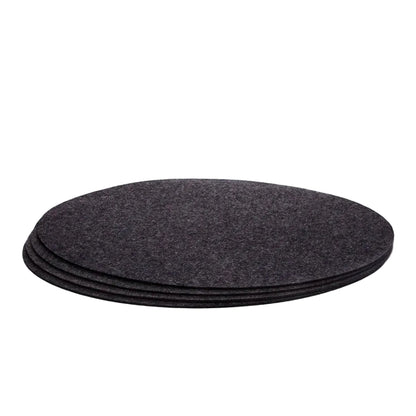 A set of four charcoal gray Merino wool felt placemats stacked on top of each other.
