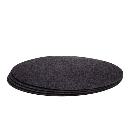 A set of four charcoal gray Merino wool felt placemats stacked on top of each other.