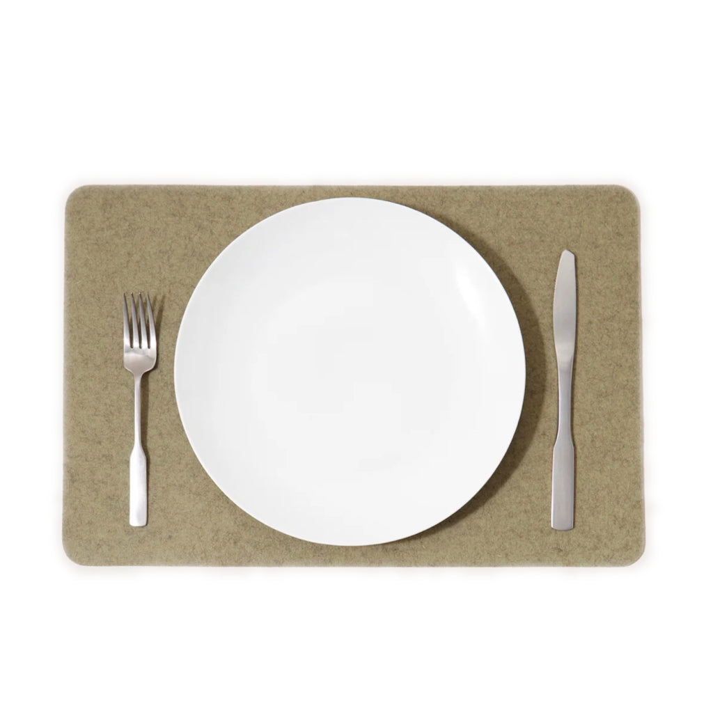 A white rectangle placemat on a table with a fork on the left side and a knife on the right side, made from Merino wool.