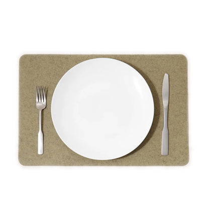 A white rectangle placemat on a table with a fork on the left side and a knife on the right side, made from Merino wool.