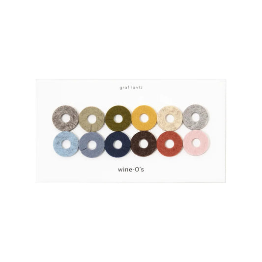 Set of colourful circular wine markers labelled 'wine-O's' by graf lantz on a white background.