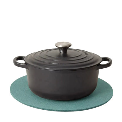 Graf Lantz Merino Wool Round Trivet in Spruce, with a cast Iron french oven on top