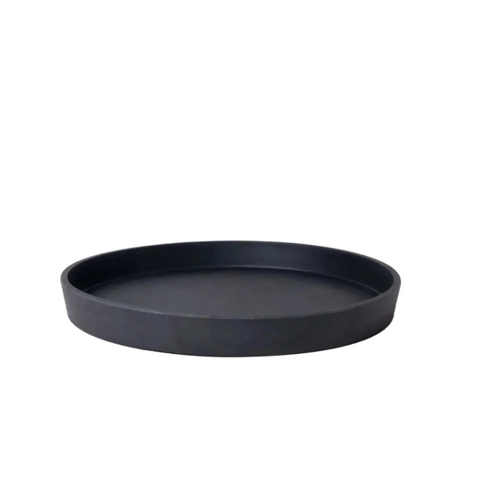 Black round tray on a light gray background