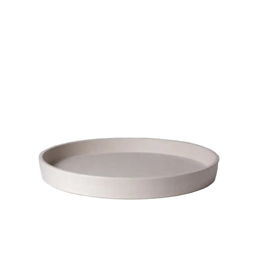Round bamboo fibre tray on a light gray background