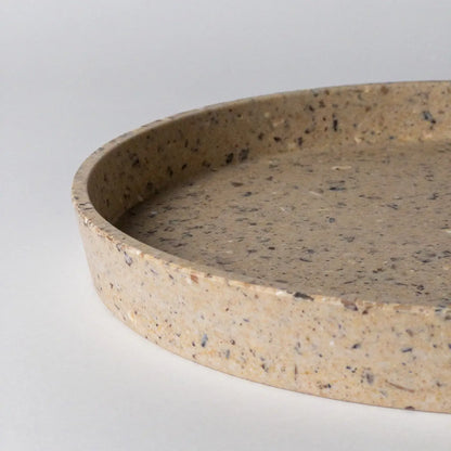 Round coffee bean husk tray on a light gray background by kinso designs