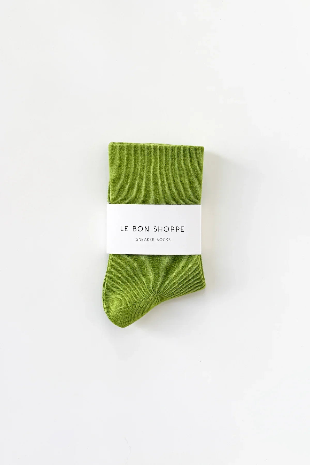 Green sock with a white label on a white background
