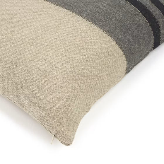 Textured pillow with beige, gray, and black stripes on a white background