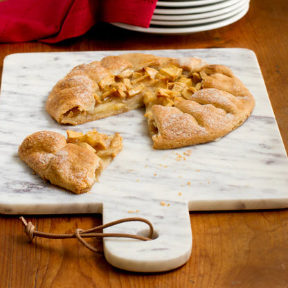 Pastry on a marble cutting board on a wooden table.