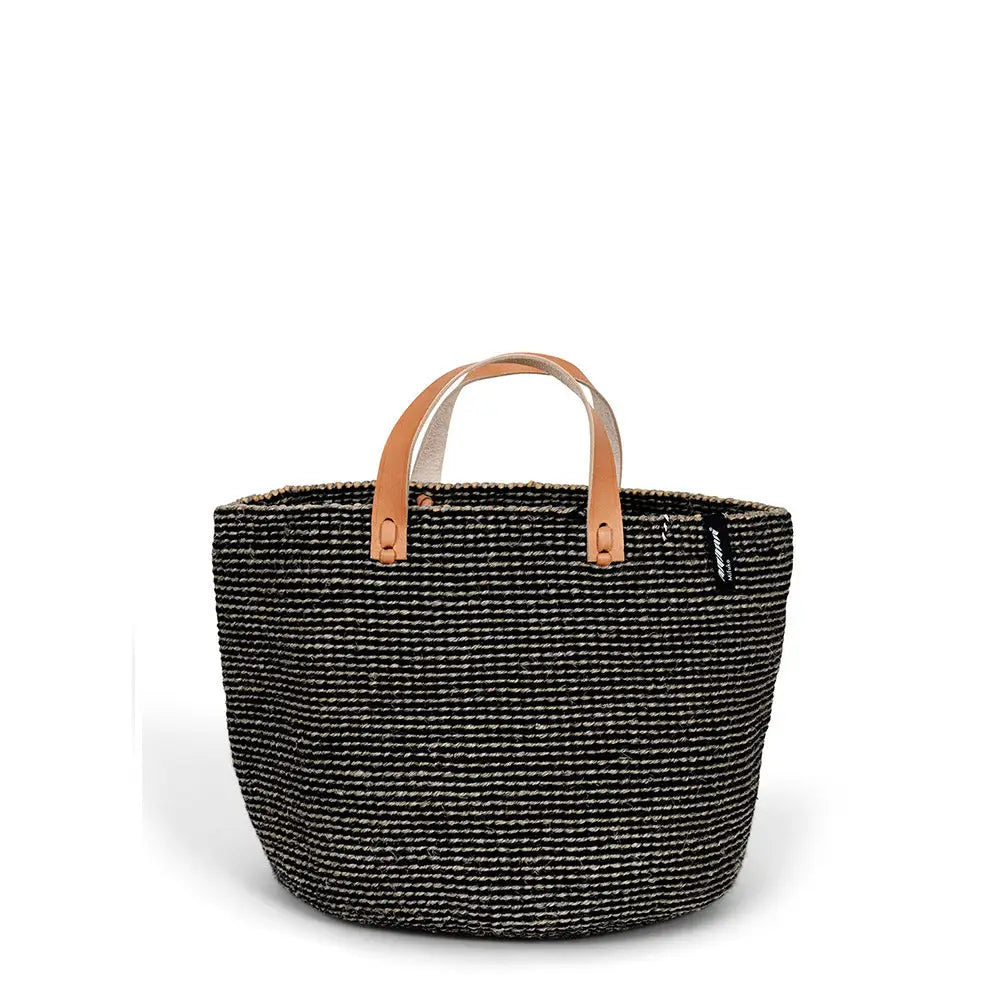 Black woven basket with leather handles on a white background