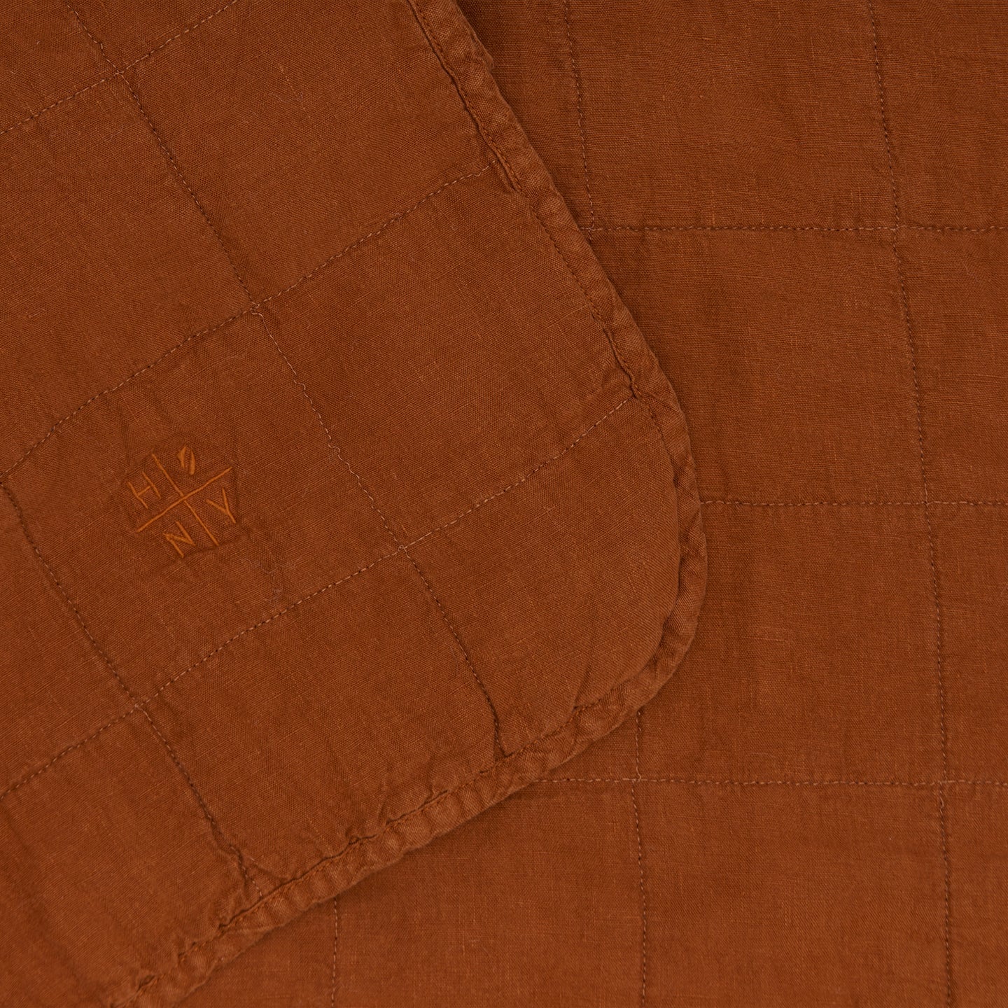 Close up of Simple Linen Quilt in Terracotta By Hawkins New York