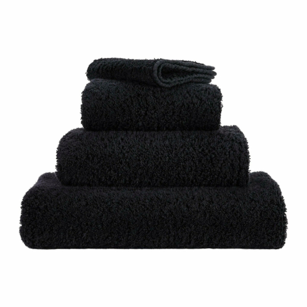 Set of black towels of different sizes on a white background