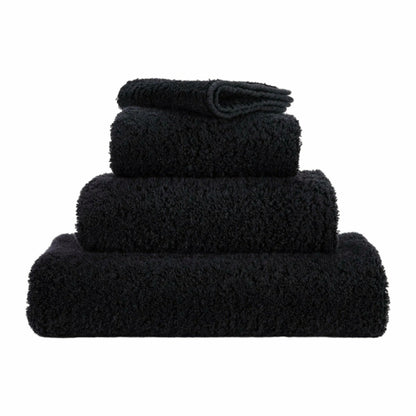 Set of black towels of different sizes on a white background