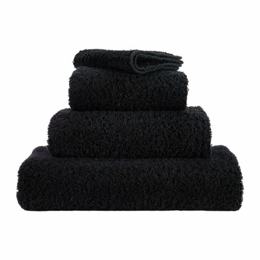 Set of black towels of different sizes on a white background