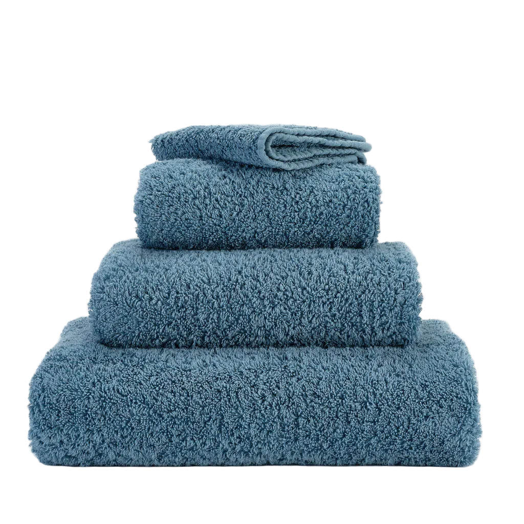 Set of blue towels stacked on a white background