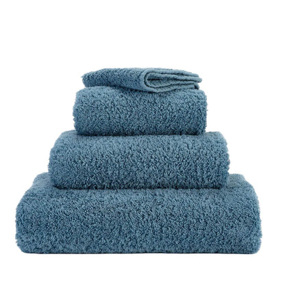 Set of blue towels stacked on a white background