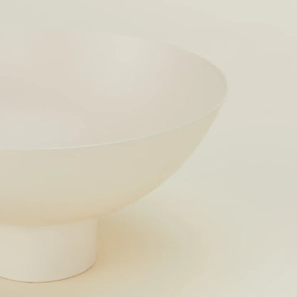 Close-up of an ivory bowl on a beige background