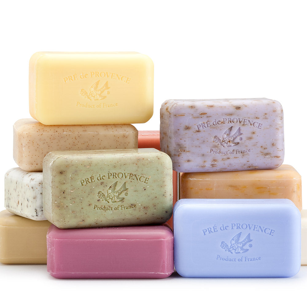 A collection of bars of soap in various colors including beige, green, brown, pink, and blue, with 'Pré de Provence' branding on the soap surface.