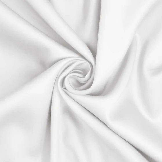 A white sateen king-size sheet set by St. Genève, neatly presented on a bed with a brand tag visible on the fabric.