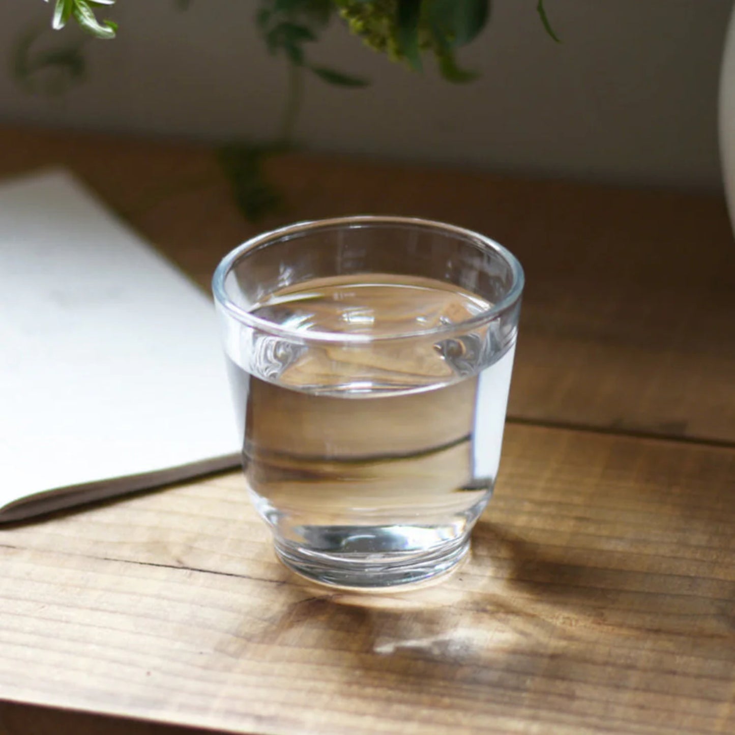 KINTO HIBI Tumbler Clear, 220ml filled with water on wooden table