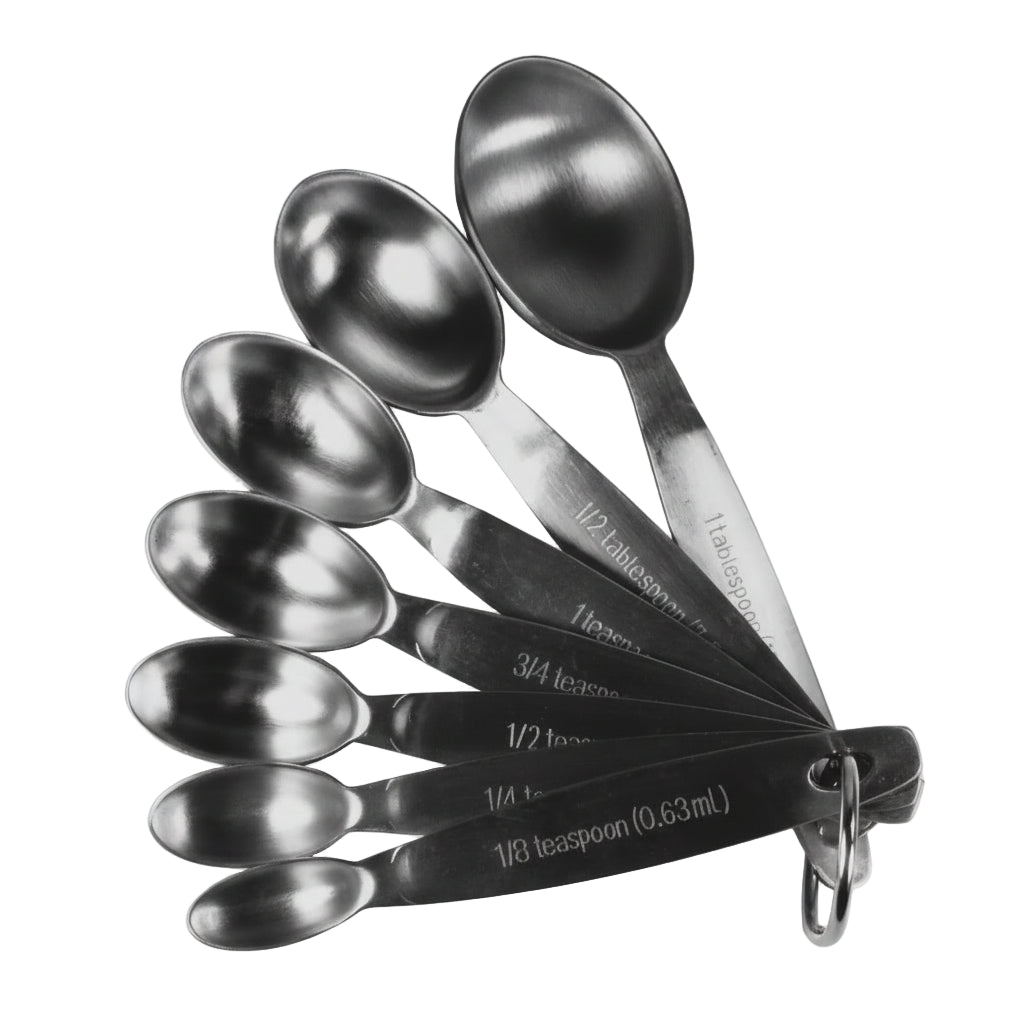 Set of stainless steel measuring spoons with measurements on a white background