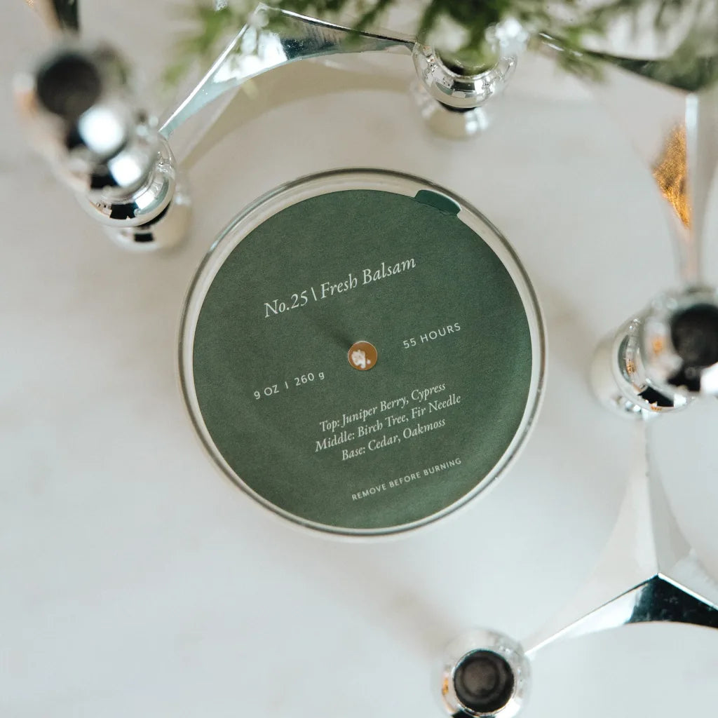 Scented candle with a label on a white surface
