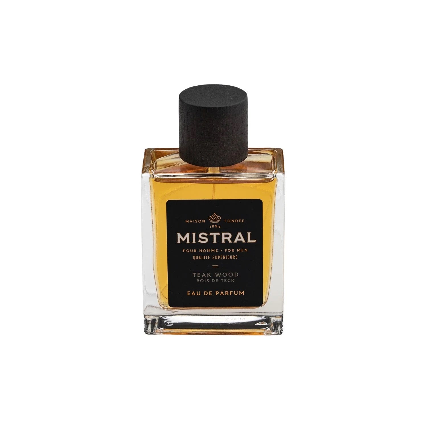 A square glass bottle of Mistral Eau de Parfum with a black cap. The label shows the fragrance name 'Teak Wood' and the bottle contains 100ml of the product.