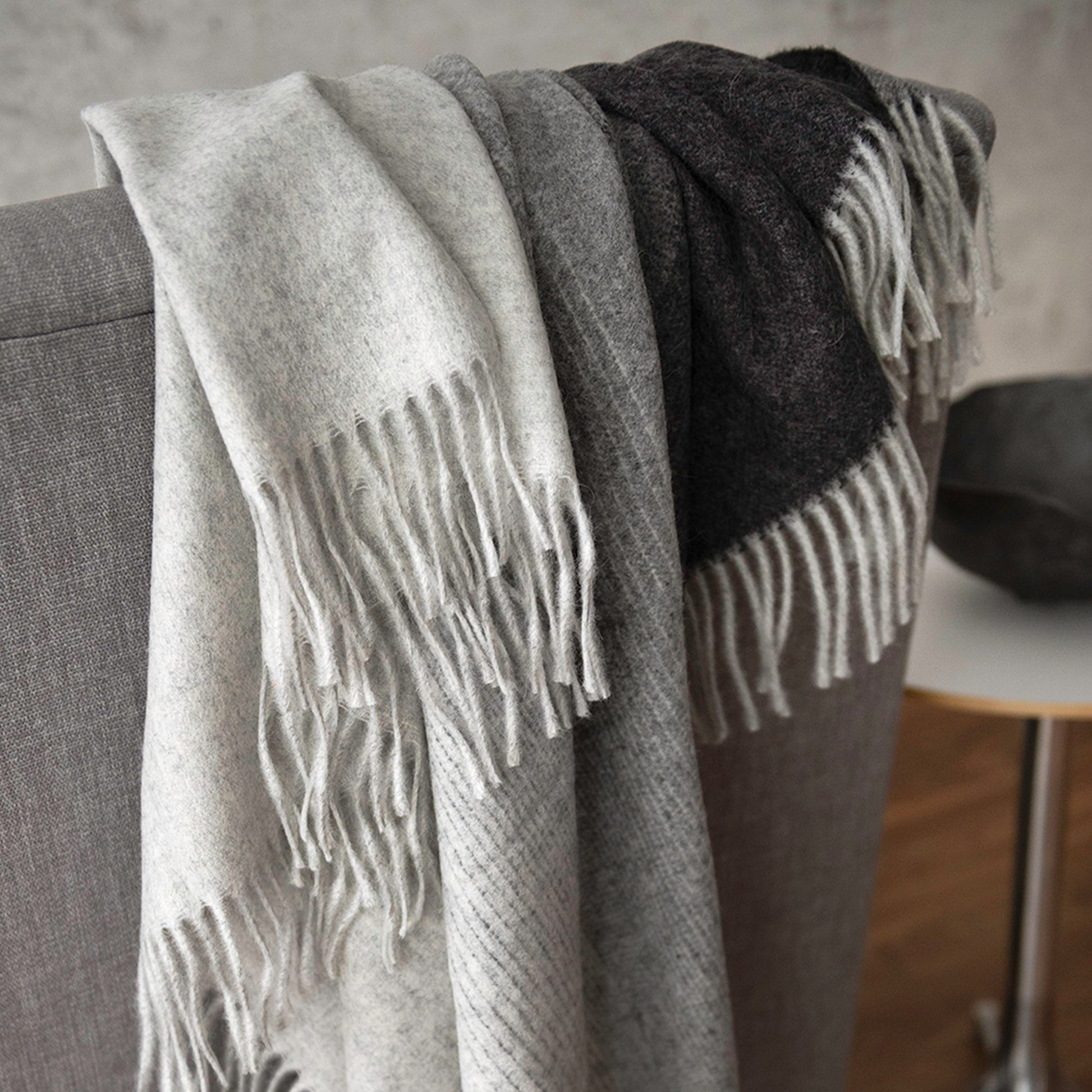 St Geneve Aria Throw in Charcoal draped over chair