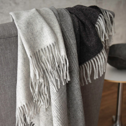 St Geneve Aria Throw in Charcoal draped over chair