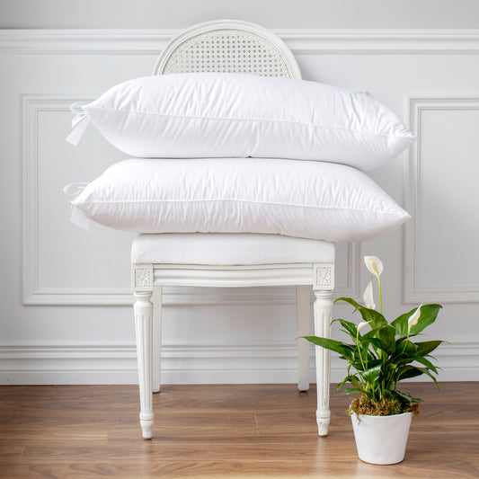 St Geneve Hutterite Down and Feather Pillows stacked on a chair