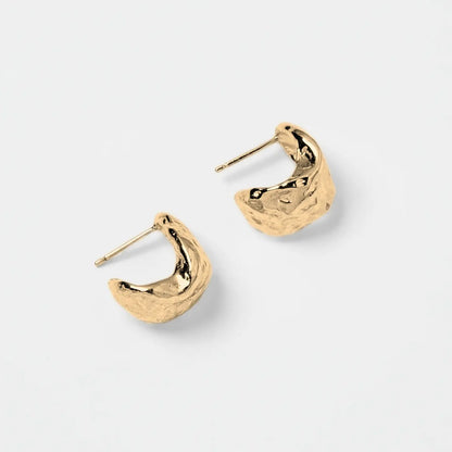 Gold hoop earrings on a light gray background