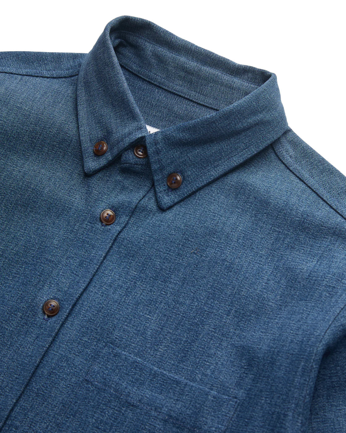 DARK BLUE DENIM SHIRT FLAY LAY CLOSEUP OF COLLAR AND BUTTONS AGAINST WHITE BACKGROUND