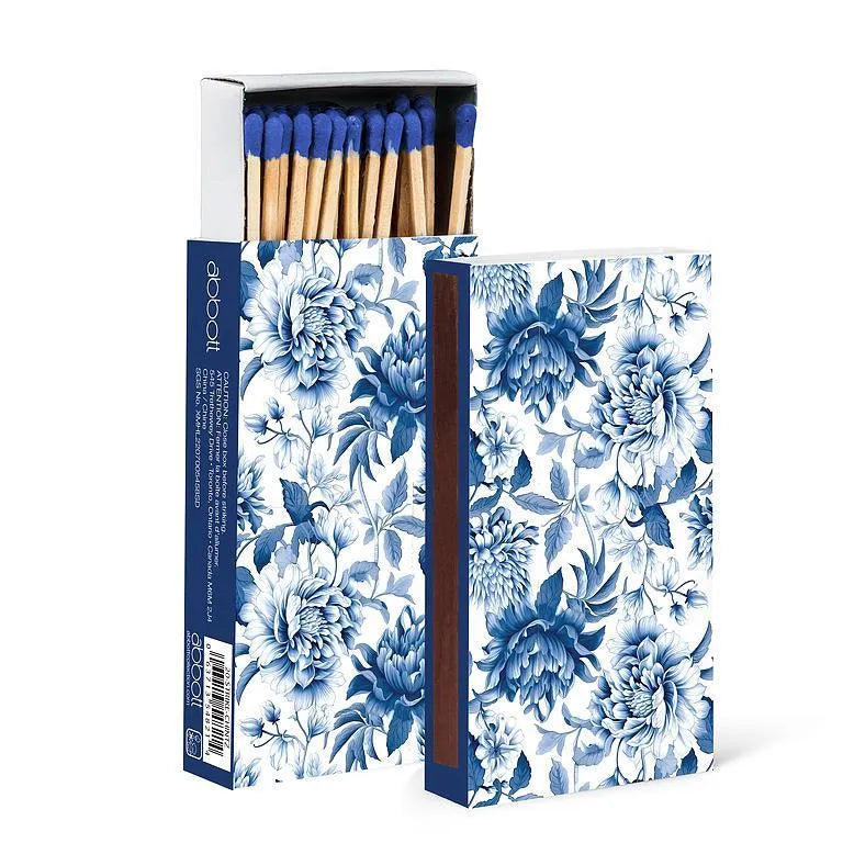Floral-patterned matchbox with matches inside on a white background