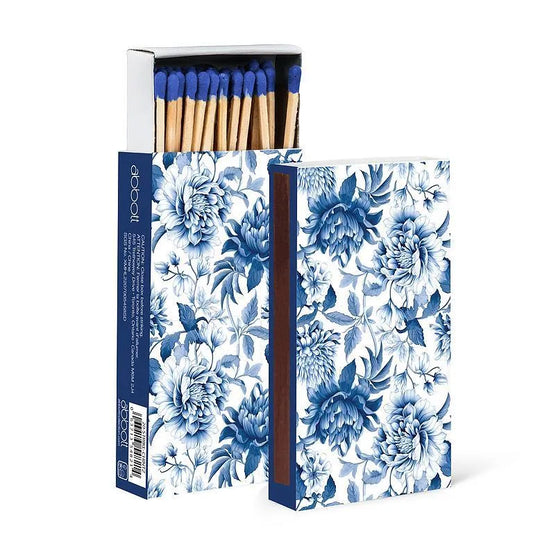 Floral-patterned matchbox with matches inside on a white background